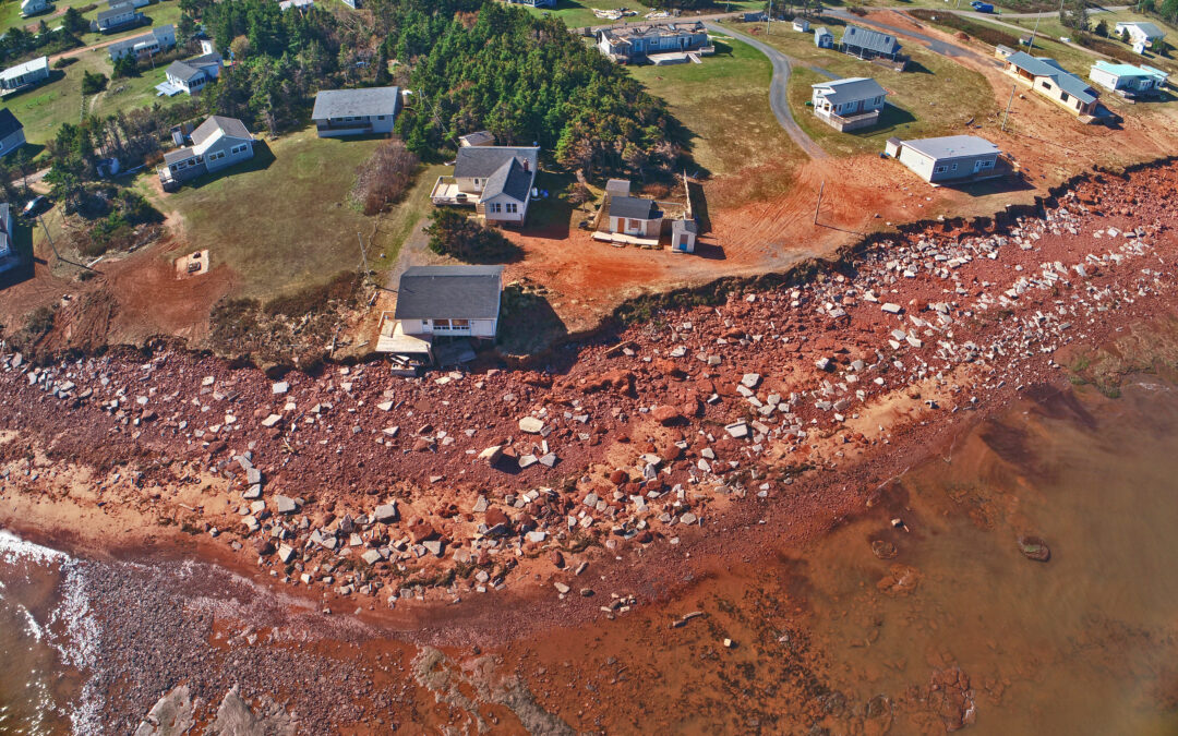 An aerial image of a PEI coastline that has eroded very close to houses.