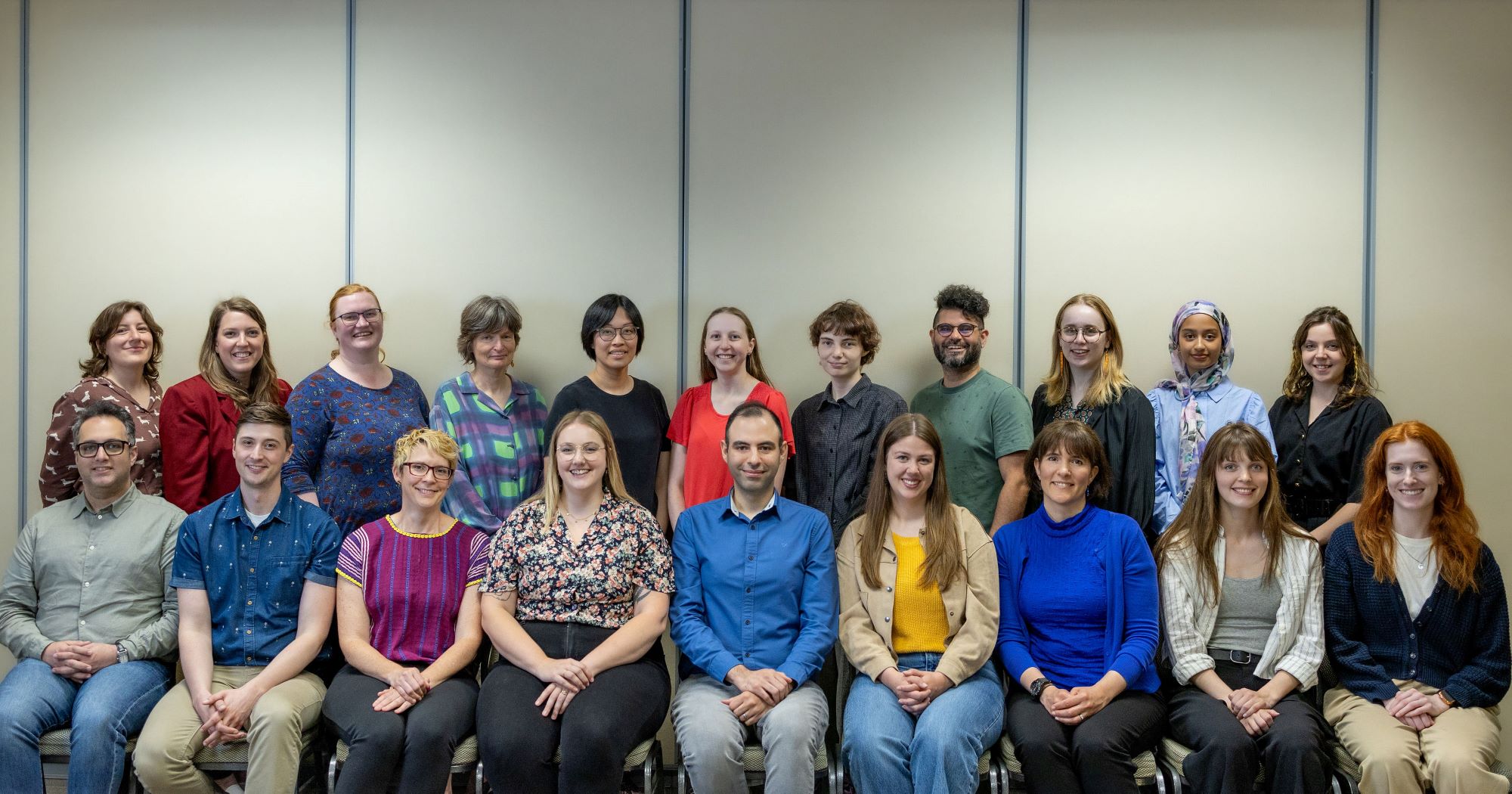 A group of 21 people pose for a photo.