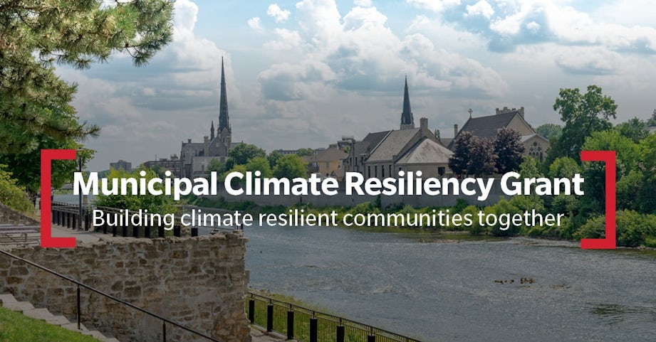 An image of a town in the background with a river in the foreground, with overlaying text that says "Municipal Climate Resiliency Grant: Building climate resilient communities together".