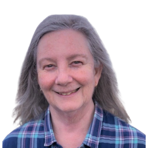 Le français suit. A picture of a person with long grey hair wearing a checkered blue shirt smiling at the camera, framed by an orange circle.Photo d'une personne aux longs cheveux gris, vêtue d'une chemise bleue à carreaux, souriant à l'appareil photo, encadrée d'un cercle orange.