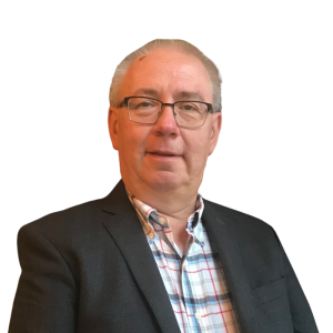 Le français suit. A picture of a person with short grey hair wearing glasses and a dark suit smiling at the camera, framed by an orange circle.<br />
Photo d'une personne aux cheveux gris courts, portant des lunettes et un costume sombre, souriant à l'appareil photo, encadrée d'un cercle orange.